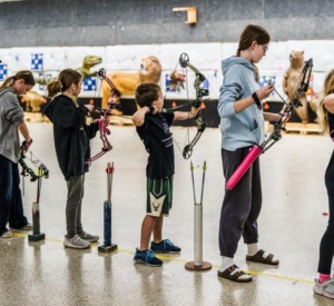 Kids shooting archery targets